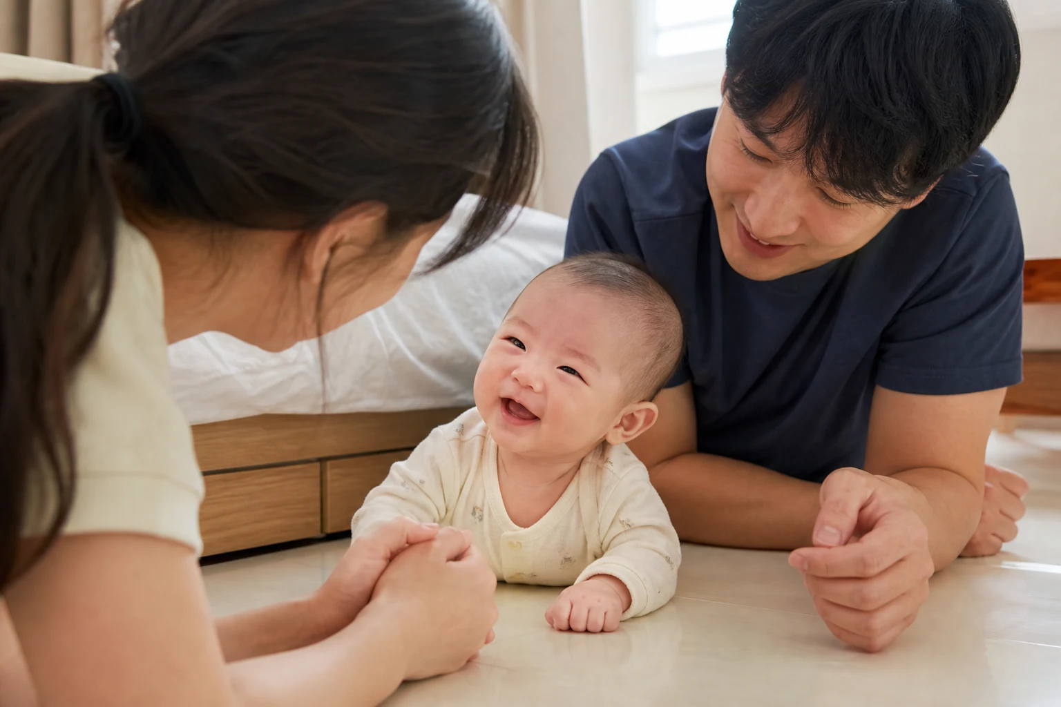 A photorealistic scene of an awake baby and real people sharing responsive vocal or social communication