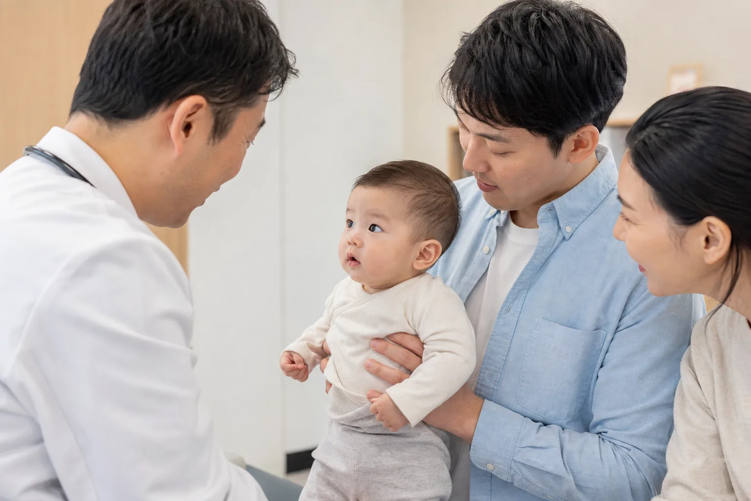 Adult caregivers measure or record an awake infant's temperature in a realistic home or pediatric clinic