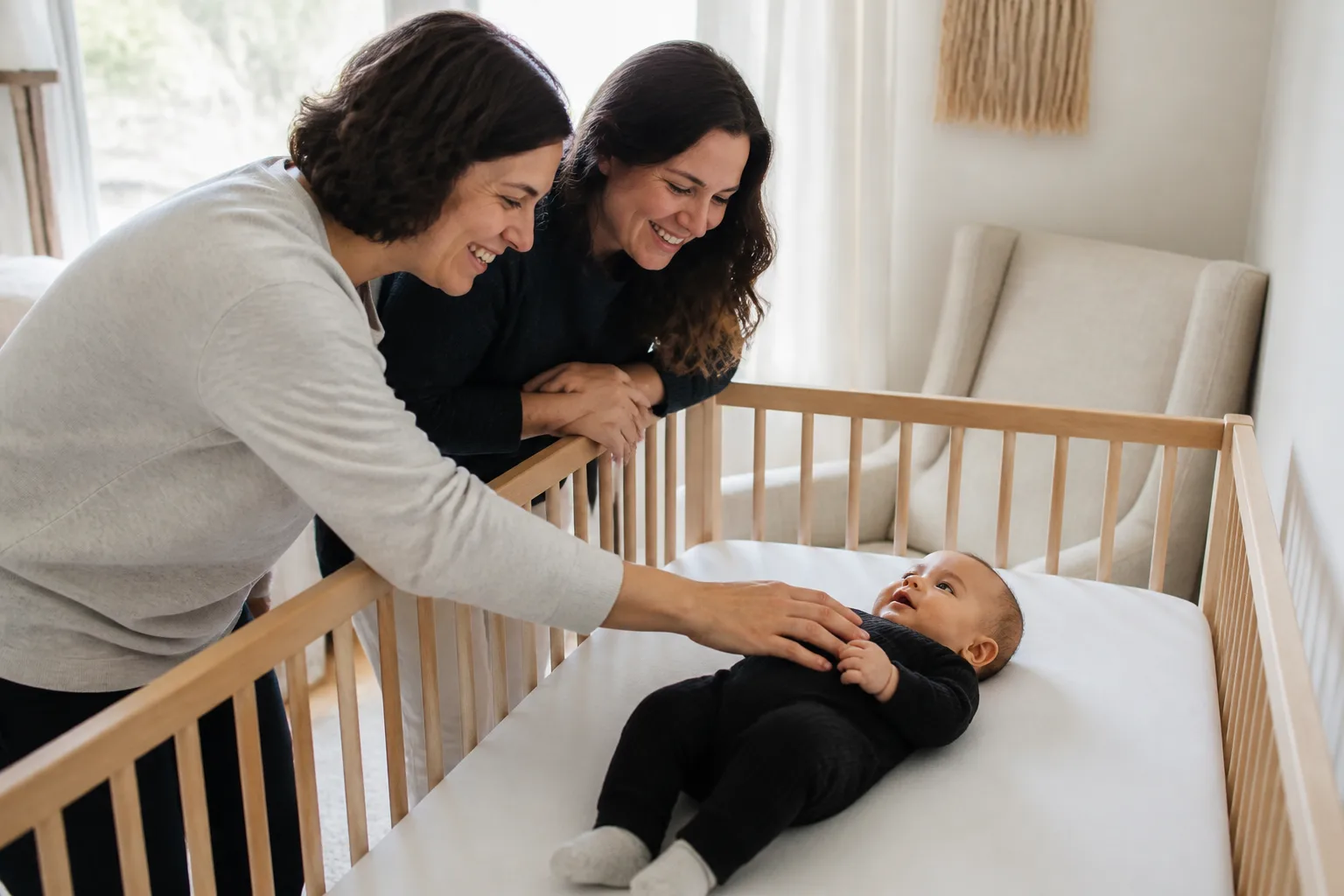 Adult caregivers observe an infant's nap cues and daily alertness in a realistic home or clinic